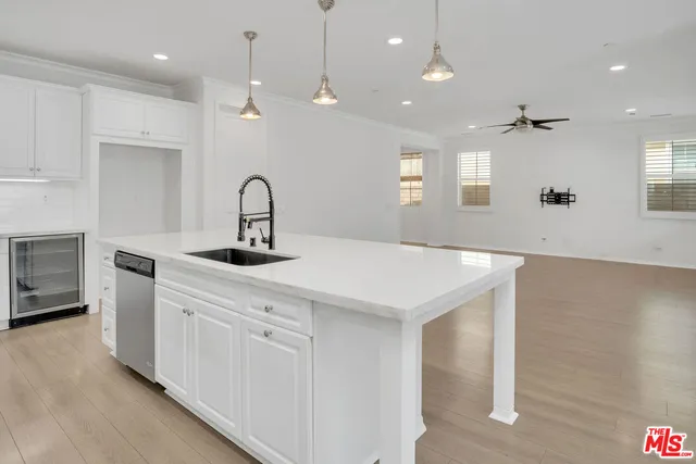 a kitchen with kitchen island a sink stainless steel appliances and a counter top