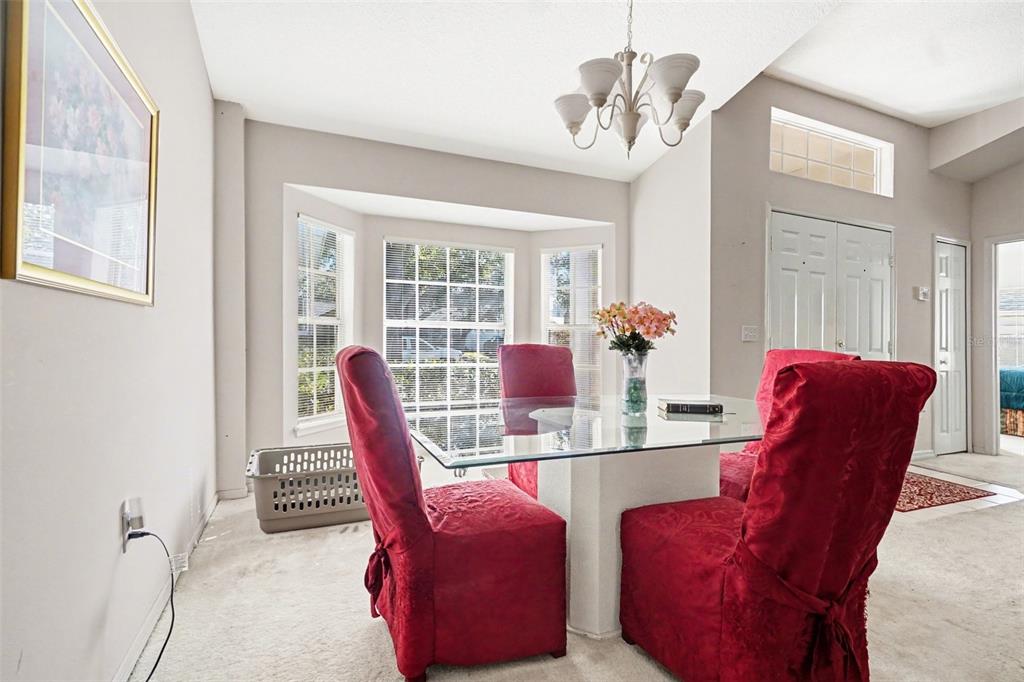 1670 East Spring Ridge Circle Winter Garden, FL 34787 - Photo 14 of 30 a dining room with furniture and wooden floor