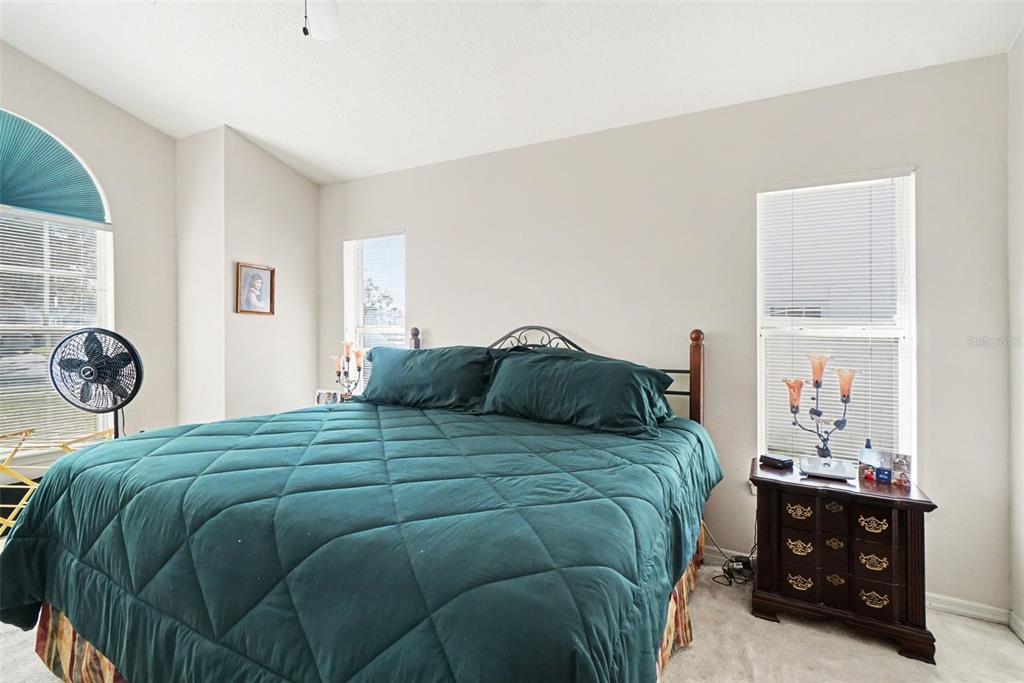 1670 East Spring Ridge Circle Winter Garden, FL 34787 - Photo 19 of 30 a bedroom with a bed and a window