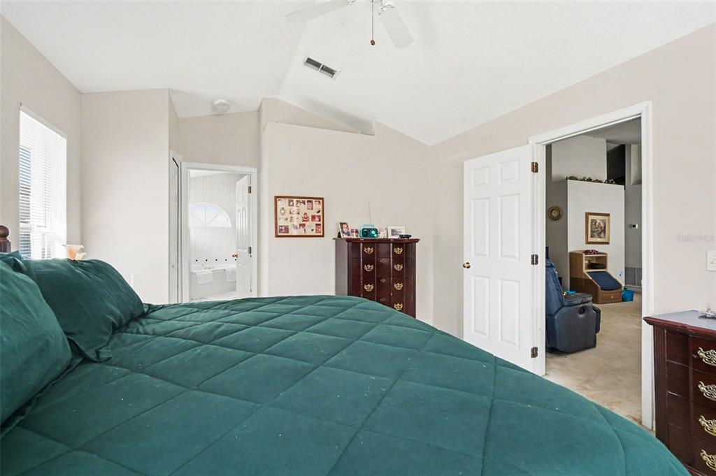 1670 East Spring Ridge Circle Winter Garden, FL 34787 - Photo 20 of 30 a bedroom with a bed and a television