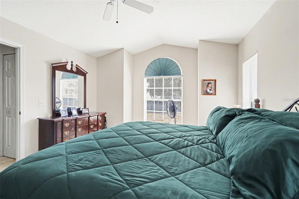 1670 East Spring Ridge Circle Winter Garden, FL 34787 - Photo 21 of 30 a bedroom with a bed a dresser and next to a window