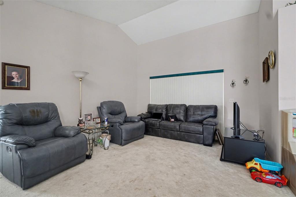 1670 East Spring Ridge Circle Winter Garden, FL 34787 - Photo 24 of 30 a living room with furniture and a couch