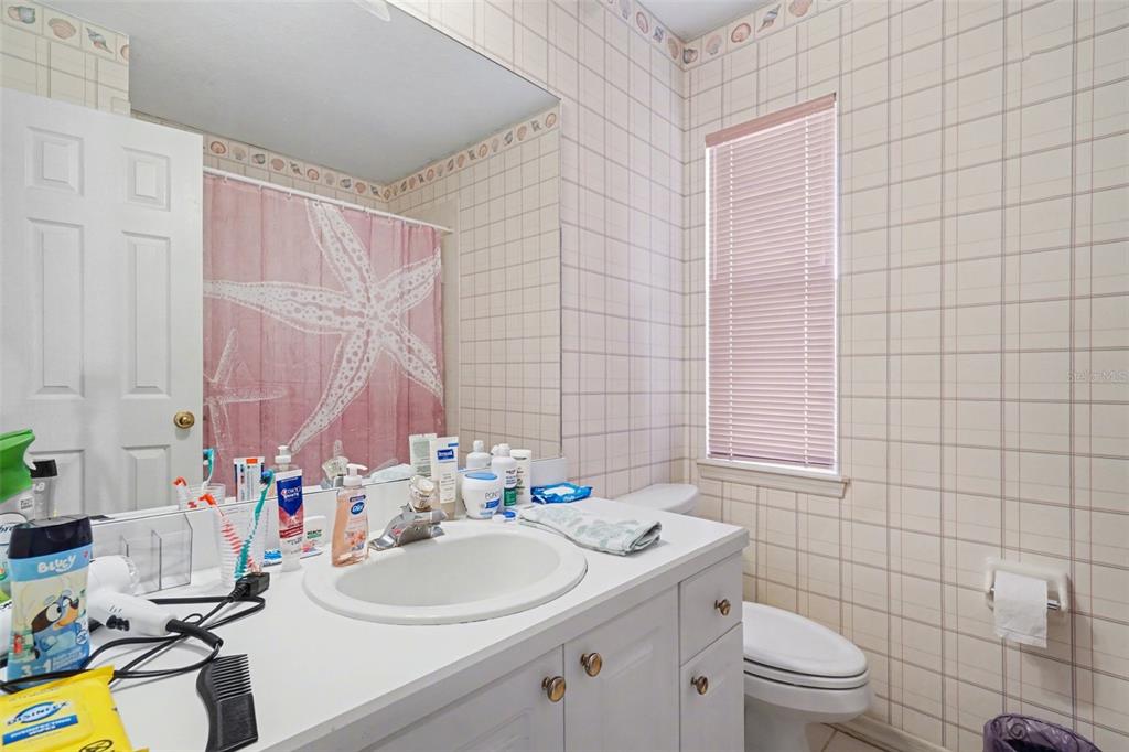 1670 East Spring Ridge Circle Winter Garden, FL 34787 - Photo 26 of 30 a bathroom with a sink mirror vanity and toilet