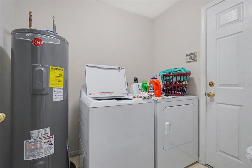 1670 East Spring Ridge Circle Winter Garden, FL 34787 - Photo 27 of 30 a utility room with dryer and washer