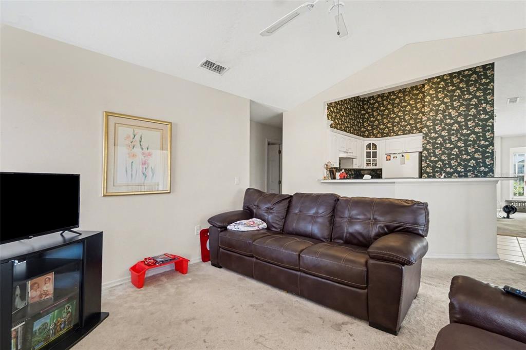 1670 East Spring Ridge Circle Winter Garden, FL 34787 - Photo 6 of 30 a living room with furniture and a flat screen tv