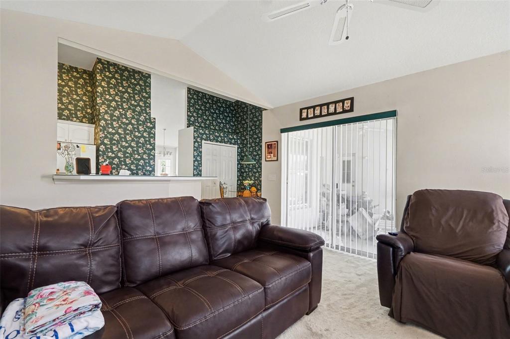 1670 East Spring Ridge Circle Winter Garden, FL 34787 - Photo 7 of 30 a living room with a couch and a large window