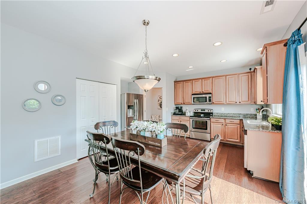 640 Alsace Lane Fort Mill, SC 29708 - Photo 11 of 36 a kitchen with kitchen island wooden cabinets and refrigerator