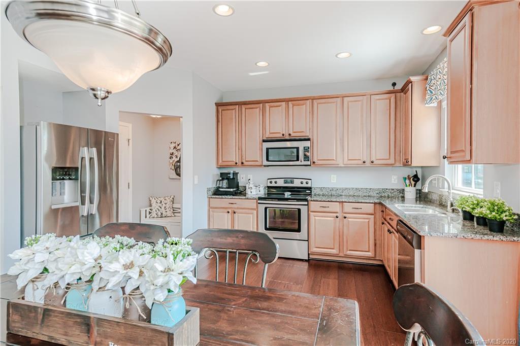 640 Alsace Lane Fort Mill, SC 29708 - Photo 12 of 36 a kitchen with granite countertop white cabinets and stainless steel appliances