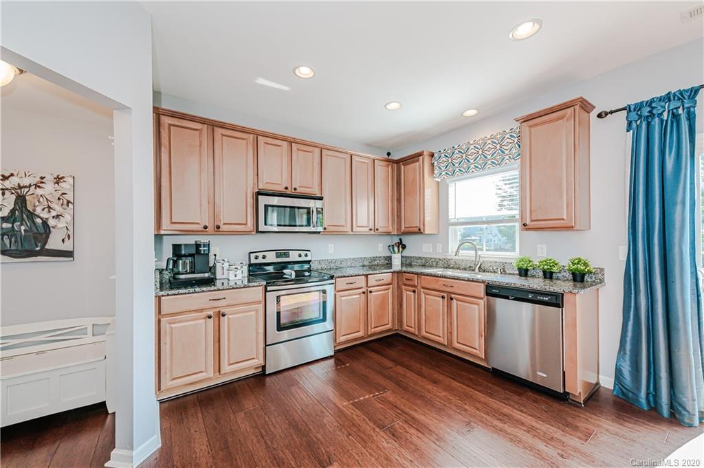 640 Alsace Lane Fort Mill, SC 29708 - Photo 14 of 36 a kitchen with stainless steel appliances a white cabinets and wooden floor