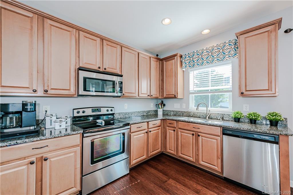 640 Alsace Lane Fort Mill, SC 29708 - Photo 15 of 36 a kitchen with stainless steel appliances granite countertop white cabinets a sink and dishwasher with wooden floor