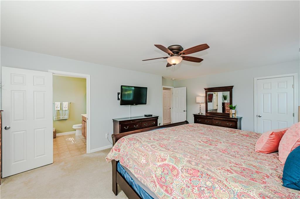 640 Alsace Lane Fort Mill, SC 29708 - Photo 22 of 36 a bedroom with a bed and a chandelier