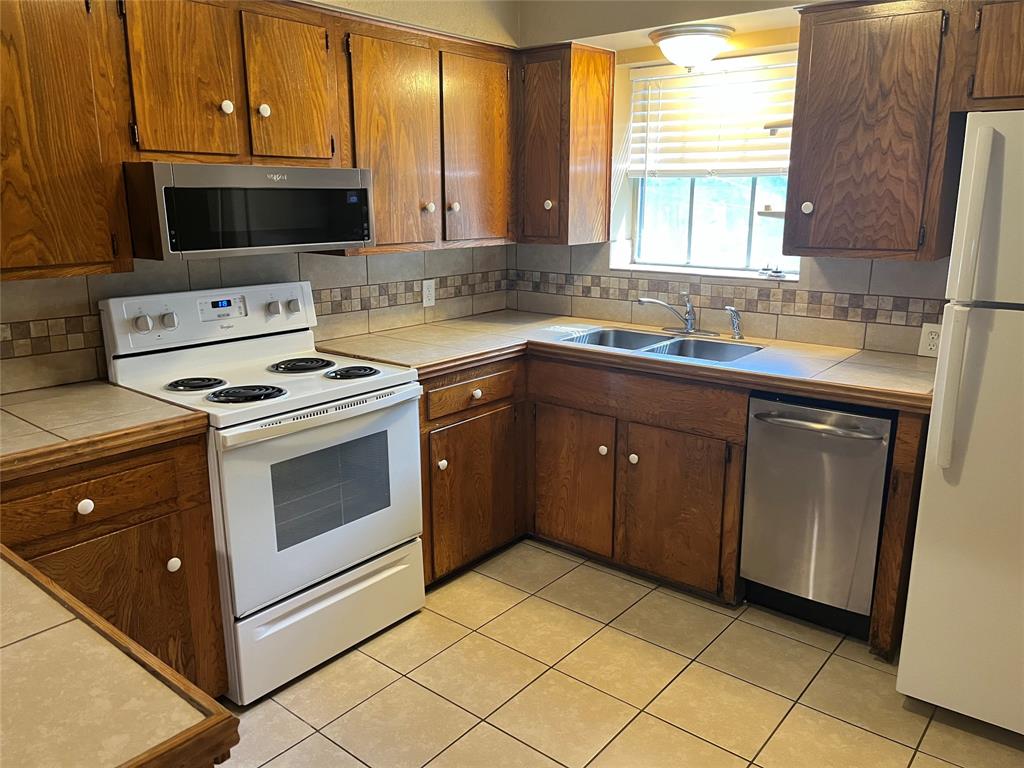 a kitchen with a stove sink and microwave