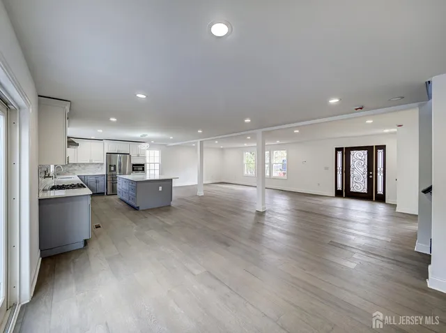 a kitchen with stainless steel appliances granite countertop a stove a sink a refrigerator and a oven