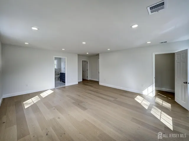 a spacious bathroom with double vanity sink a mirror and a shower