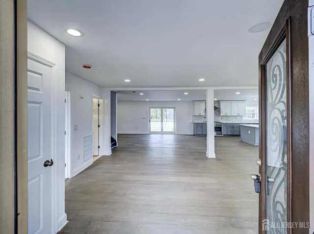 a view of a hallway with wooden shelves