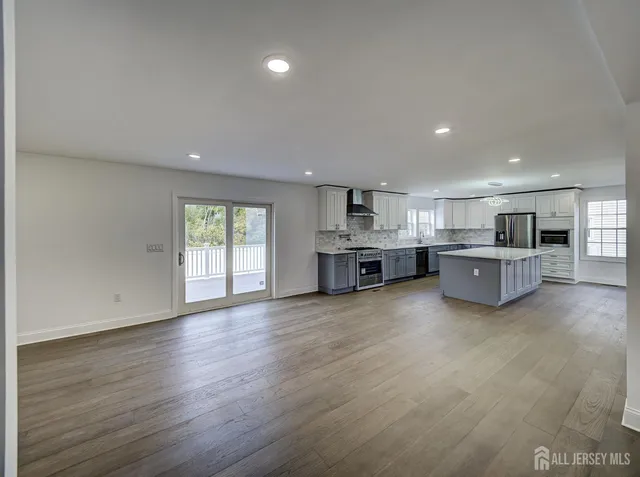 a view of kitchen with furniture and wooden floor