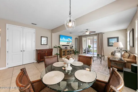 a view of a dining room with furniture a rug and wooden floor