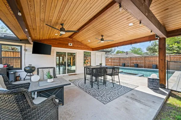 a patio view with a table and chairs