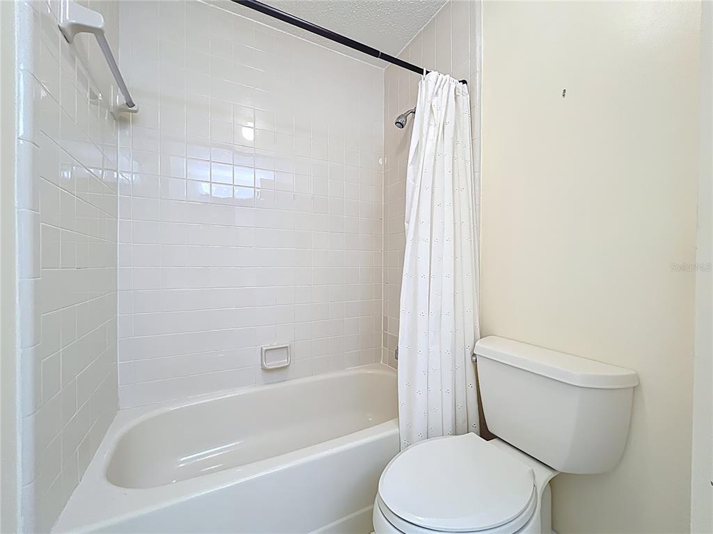 2843 Danforth Drive Orlando, FL 32818 - Photo 15 of 41 a white toilet sitting next to a bath tub