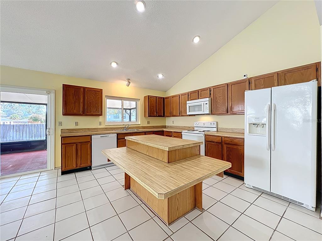 2843 Danforth Drive Orlando, FL 32818 - Photo 21 of 41 a kitchen with stainless steel appliances a refrigerator sink and microwave