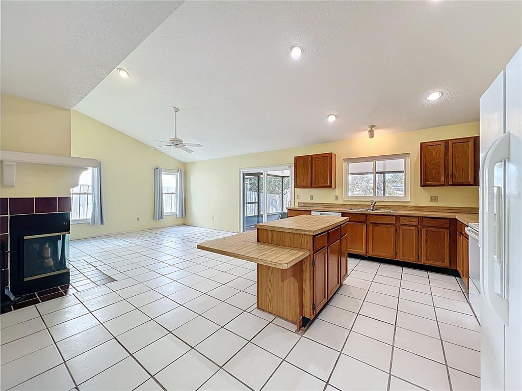 2843 Danforth Drive Orlando, FL 32818 - Photo 30 of 41 a kitchen with stainless steel appliances granite countertop a stove top oven a sink dishwasher and a refrigerator