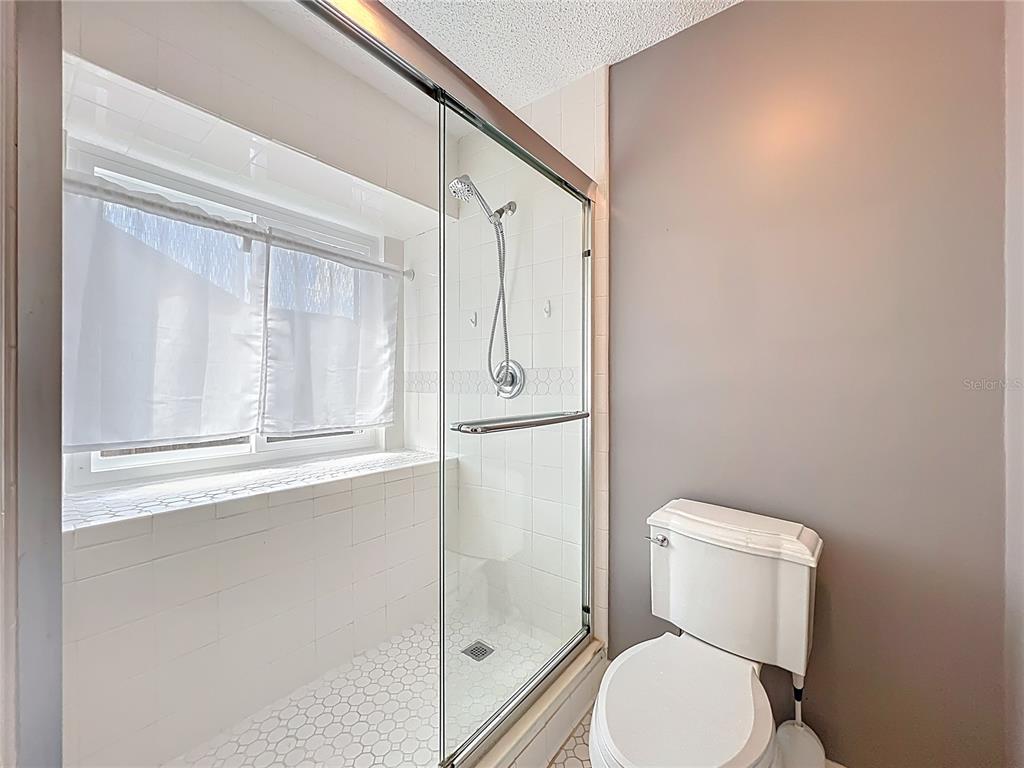 2843 Danforth Drive Orlando, FL 32818 - Photo 34 of 41 a bathroom with a toilet a sink and shower