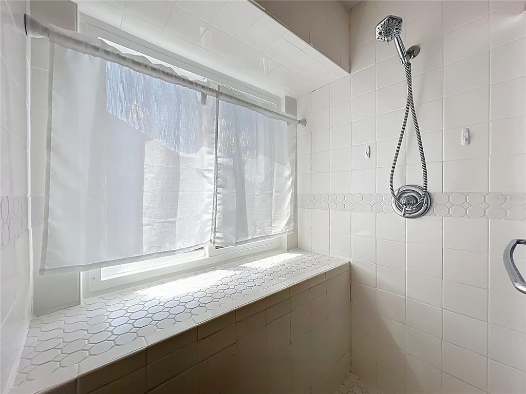 2843 Danforth Drive Orlando, FL 32818 - Photo 35 of 41 a bathroom with a granite countertop sink and a mirror