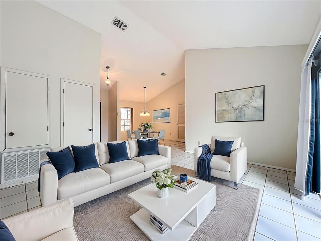 2843 Danforth Drive Orlando, FL 32818 - Photo 4 of 41 a living room with furniture a rug and a table