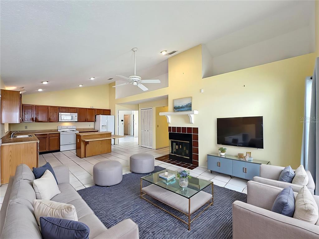 2843 Danforth Drive Orlando, FL 32818 - Photo 8 of 41 a living room with furniture kitchen view and a flat screen tv