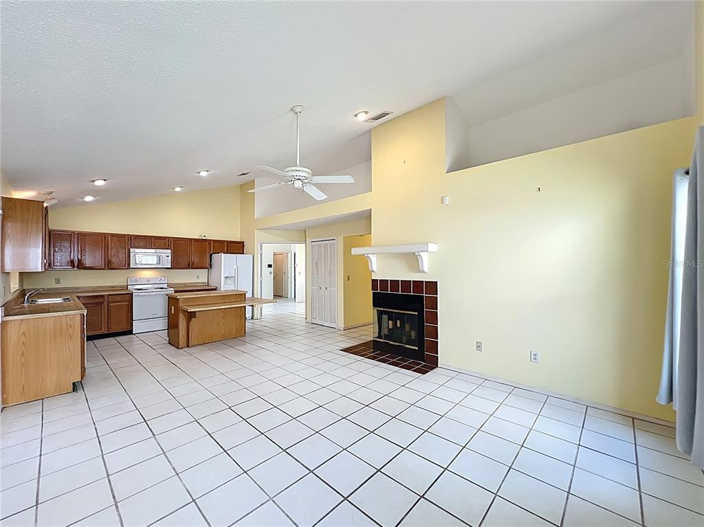 2843 Danforth Drive Orlando, FL 32818 - Photo 9 of 41 a kitchen with stainless steel appliances a refrigerator and a sink