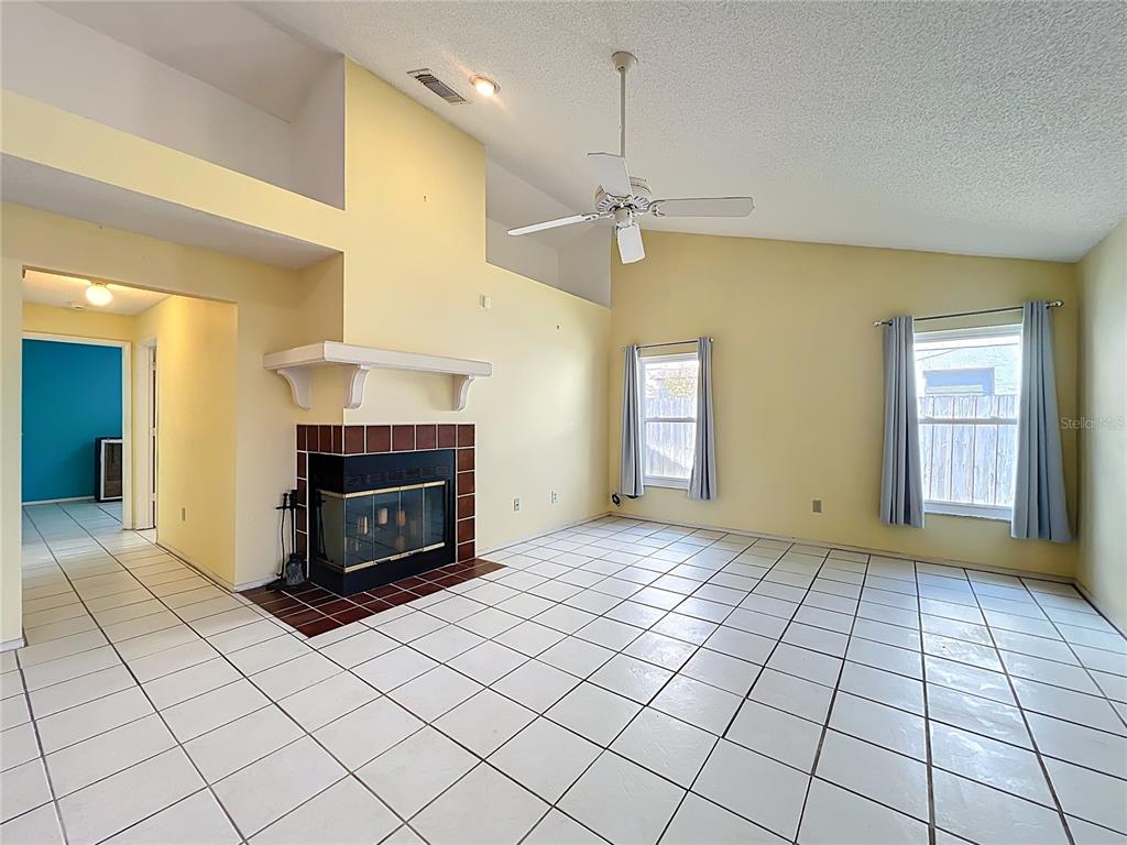 2843 Danforth Drive Orlando, FL 32818 - Photo 10 of 41 a view of an empty room with a fireplace and a window