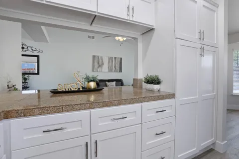 a kitchen with granite countertop a sink stainless steel appliances and cabinets