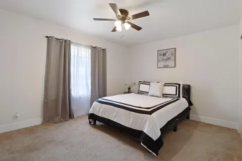 a bedroom with bed and a chandelier