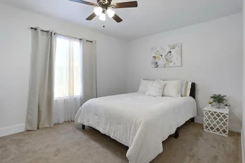 a bedroom with bed and a chandelier
