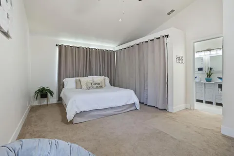 a spacious bedroom with a bed and a table