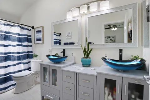 a bathroom with a sink a toilet and a mirror