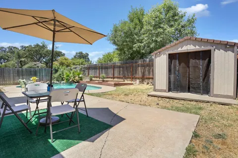 a swimming pool with outdoor seating and yard