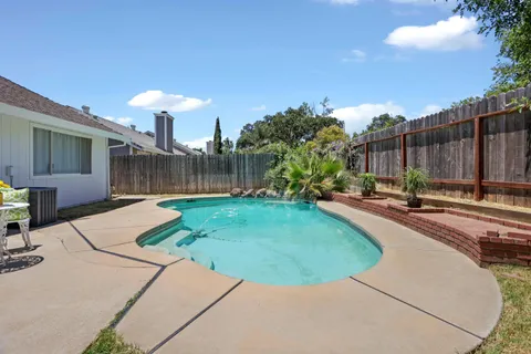 a swimming pool with outdoor seating and yard