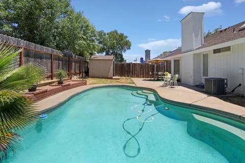 a backyard of a house with table and chairs