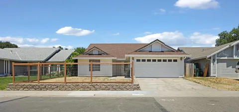 a view of a house with a garden and pathway