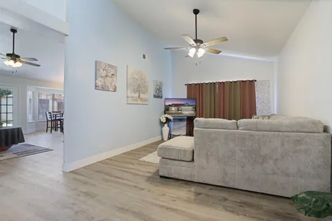 a living room with furniture and a chandelier