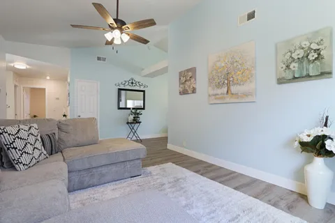 a living room with furniture and a chandelier