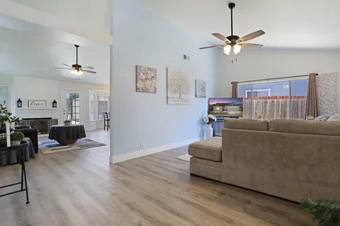 a living room with furniture and a wooden floor