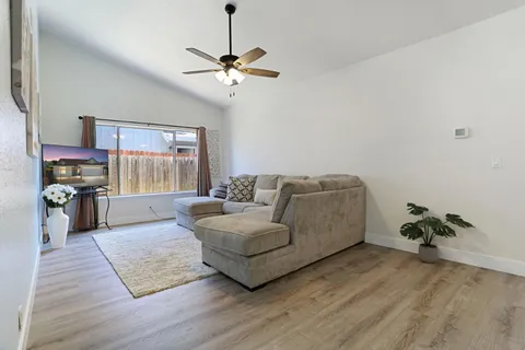 a living room with furniture and a chandelier