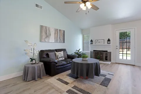 a living room with furniture and a fireplace