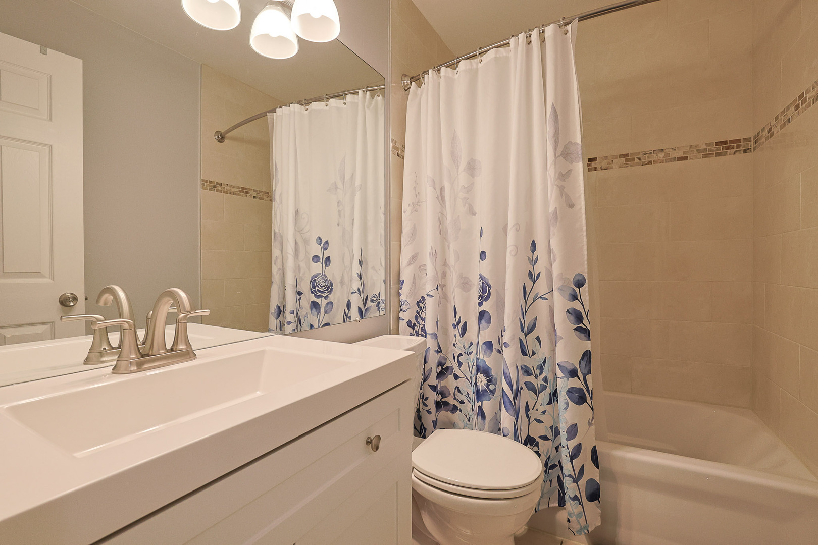 830 Hawk Lane Carol Stream, IL 60188 - Photo 19 of 30 a bathroom with a sink a toilet and shower curtain