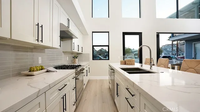 a kitchen with stainless steel appliances granite countertop a sink stove and cabinets