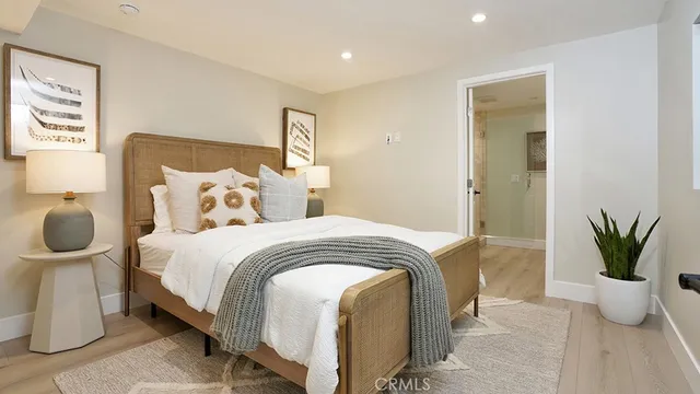 a bedroom with bed and a potted plant