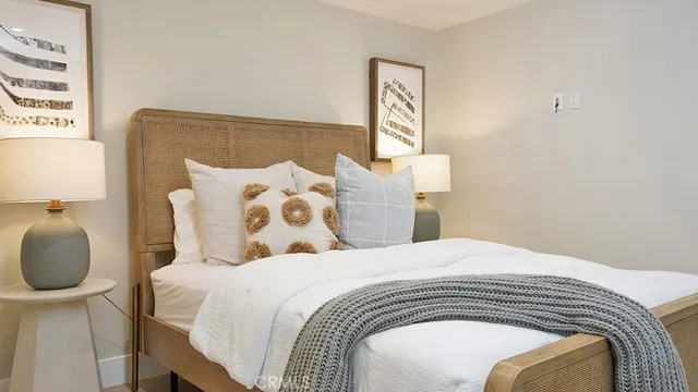 a bedroom with a bed and lamp