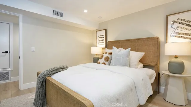 a bedroom with a bed and a night stand